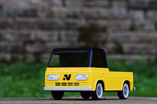 Die-cast scale model pickup truck, yellow body with black roof and pillars on cab